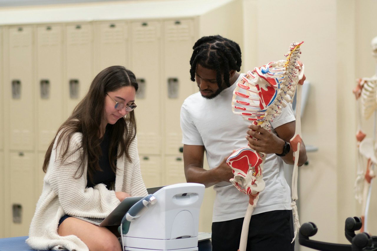 Clinician explaining an anatomical model to a colleague